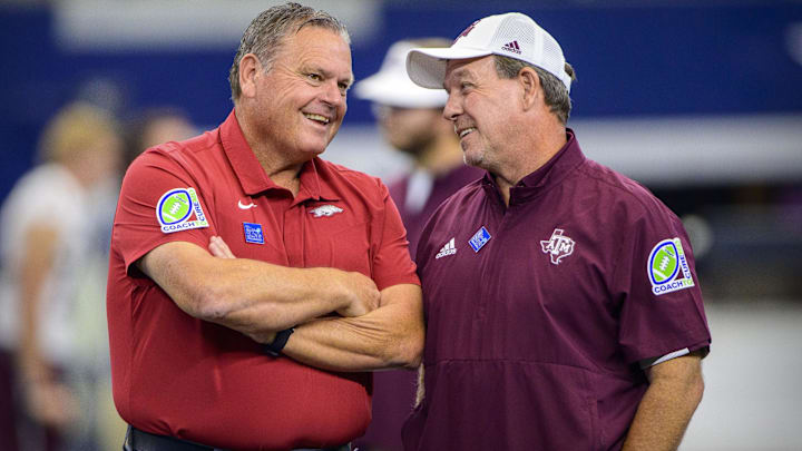 Arkansas head coach Sam Pittman (left) talks with Texas A&M head coach Jimbo Fisher (right) before the game between the Razorbacks and the Texas Aggies at AT&T Stadium. 