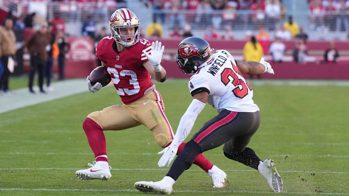 Nov 19, 2023; Santa Clara, California, USA; San Francisco 49ers running back Christian McCaffrey (23) carries the ball against Tampa Bay Buccaneers safety Antoine Winfield Jr. (31) during the second quarter at Levi's Stadium. Mandatory Credit: Darren Yamashita-Imagn Images