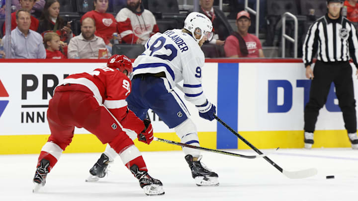 Oct 3, 2024; Detroit, Michigan, USA;  Toronto Maple Leafs left wing Alex Nylander (92) skates with the puck defended by Detroit Red Wings right wing Alex DeBrincat (93) in the third period at Little Caesars Arena. Mandatory Credit: Rick Osentoski-Imagn Images