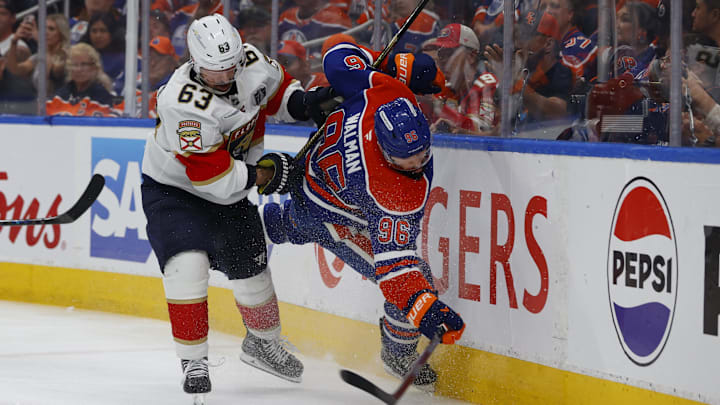 Florida Panthers forward Brad Marchand boards Edmonton Oilers defenseman Jake Walman 