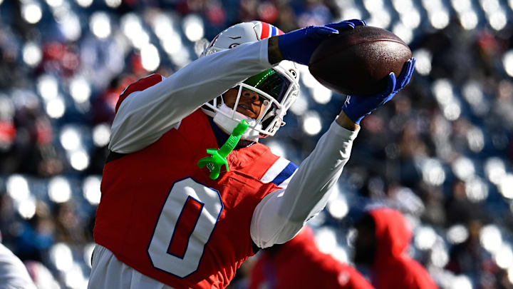 Dec 1, 2024; Foxborough, Massachusetts, USA; New England Patriots cornerback Christian Gonzalez (0) warms up before a game against the Indianapolis Colts at Gillette Stadium. Mandatory Credit: Eric Canha-Imagn Images
