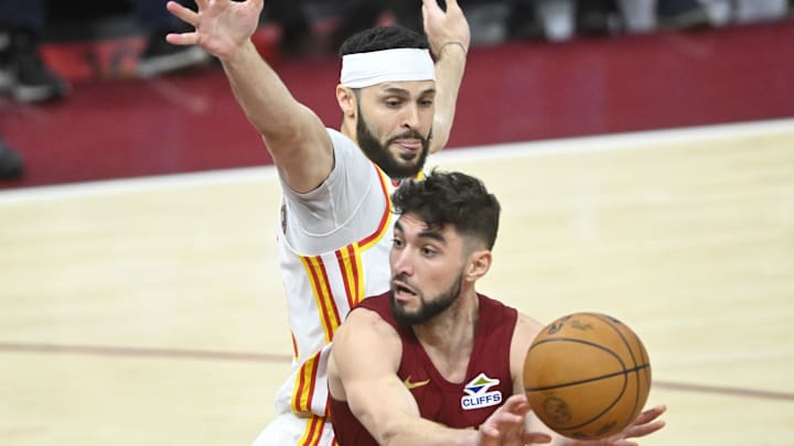 Jan 30, 2025; Cleveland, Ohio, USA; Cleveland Cavaliers guard Ty Jerome (2) throws a pass beside Atlanta Hawks forward Larry Nance Jr. (22) in the third quarter at Rocket Mortgage FieldHouse. Mandatory Credit: David Richard-Imagn Images