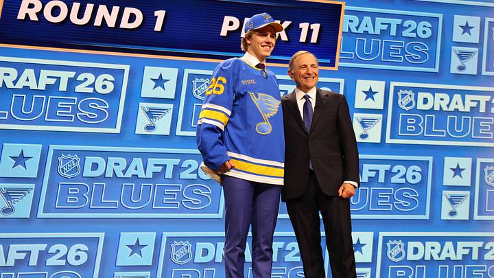 Jun 26, 2026; Buffalo, New York, USA; Tynan Lawrence poses beside NHL commissioner Gary Bettman after being selected with the eleventh pick in the first round of the 2026 NHL Draft by the St. Louis Blues at KeyBank Center. Mandatory Credit: Timothy T. Ludwig-Imagn Images