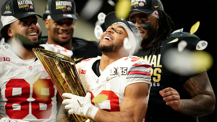 Ohio State running back TreVeyon Henderson (32) holds the national championship trophy after his team's defeat of Notre Dame in the College Football Playoff title game at Mercedes-Benz Stadium in Atlanta on Jan. 21, 2025. Ohio State running back TreVeyon Henderson (32) holds the national championship trophy after his team's defeat of Notre Dame in the College Football Playoff title game at Mercedes-Benz Stadium in Atlanta on Jan. 21, 2025.
