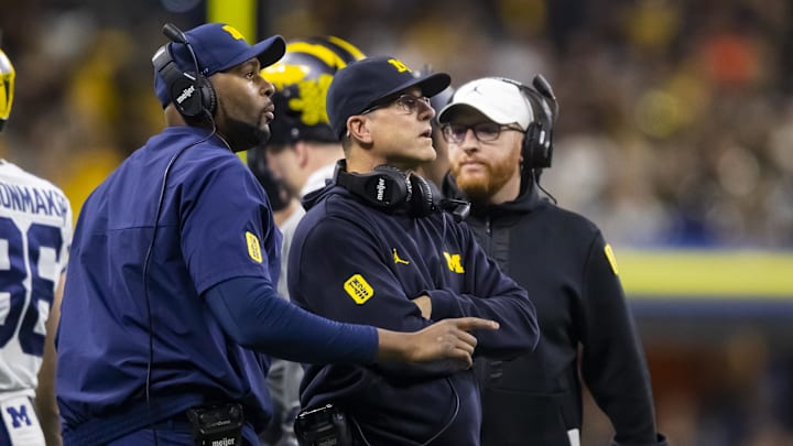 Dec 4, 2021; Indianapolis, IN, USA; Michigan Wolverines offensive line coach Sherrone Moore (left) and head coach Jim Harbaugh (center). Dec 4, 2021; Indianapolis, IN, USA; Michigan Wolverines offensive line coach Sherrone Moore (left) and head coach Jim Harbaugh (center).