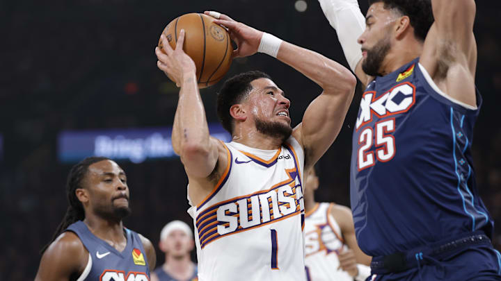Apr 22, 2026; Oklahoma City, Oklahoma, USA; Phoenix Suns guard Devin Booker (1) drives to the basket as Oklahoma City Thunder guard Ajay Mitchell (25) defends in the first half during game two of the first round of the 2026 NBA Playoffs at Paycom Center. Mandatory Credit: Alonzo Adams-Imagn Images