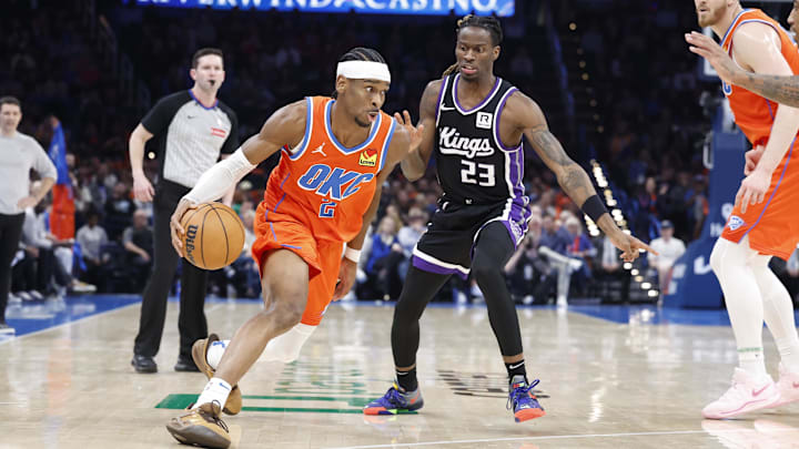 Feb 1, 2025; Oklahoma City, Oklahoma, USA; Oklahoma City Thunder guard Shai Gilgeous-Alexander (2) drives to the basket around Sacramento Kings guard Keon Ellis (23) during the second half at Paycom Center. Mandatory Credit: Alonzo Adams-Imagn Images