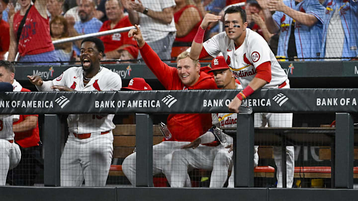 Sep 18, 2024; St. Louis, Missouri, USA;  St. Louis Cardinals right fielder Lars Nootbaar (21)  Luken Baker (26) and right fielder Jordan Walker (18) reacts after first baseman Paul Goldschmidt (not pictured) hit a one run triple against the Pittsburgh Pirates during the third inning at Busch Stadium. Mandatory Credit: Jeff Curry-Imagn Images