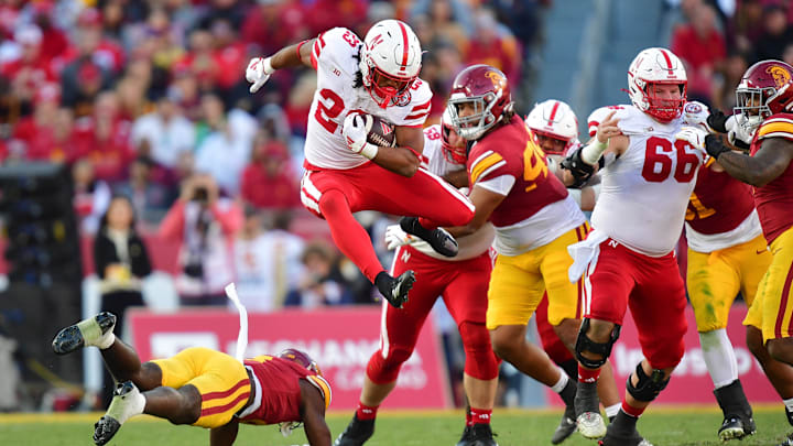Nov 16, 2024; Los Angeles, California, USA; Nebraska Cornhuskers running back Dante Dowdell (23) jumps over Southern California Trojans safety Zion Branch (8) during the second half at the Los Angeles Memorial Coliseum.