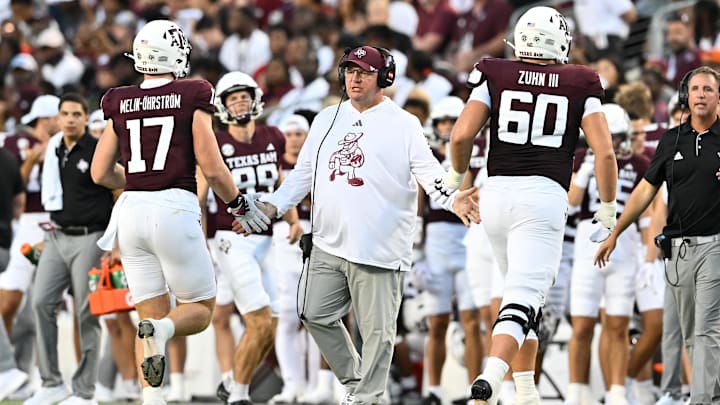 Texas A&M Aggies head coach Mike Elko high fives players as they exit the field during the second quarter against the Notre Dame Fighting Irish at Kyle Field. Texas A&M Aggies head coach Mike Elko high fives players as they exit the field during the second quarter against the Notre Dame Fighting Irish at Kyle Field.