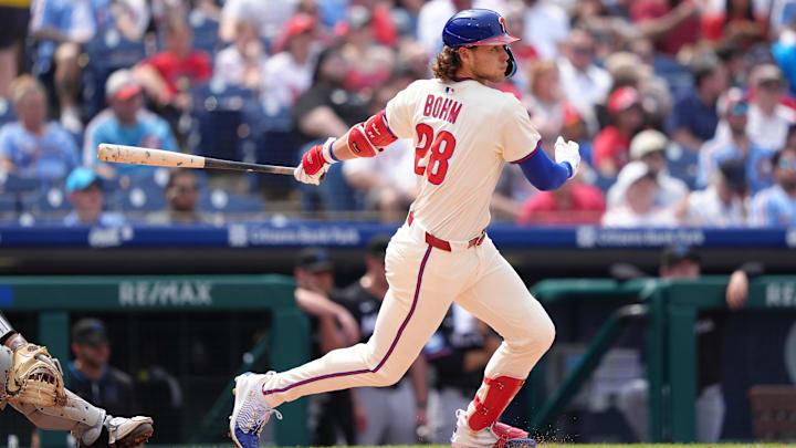 Apr 19, 2025; Philadelphia, Pennsylvania, USA; Philadelphia Phillies infielder Alec Bohm (28) hits a single against the Miami Marlins in the fourth inning at Citizens Bank Park.