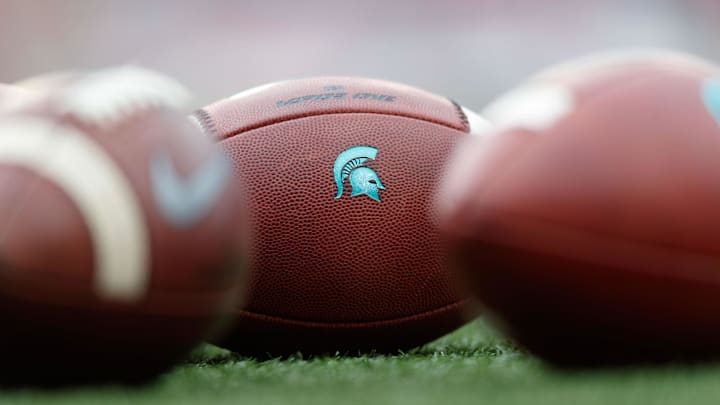 Oct 12, 2019; Madison, WI, USA; Michigan State Spartans logo on footballs during warmups prior to the game against the Wisconsin Badgers at Camp Randall Stadium. Mandatory Credit: Jeff Hanisch-USA TODAY Sports Oct 12, 2019; Madison, WI, USA; Michigan State Spartans logo on footballs during warmups prior to the game against the Wisconsin Badgers at Camp Randall Stadium. Mandatory Credit: Jeff Hanisch-USA TODAY Sports