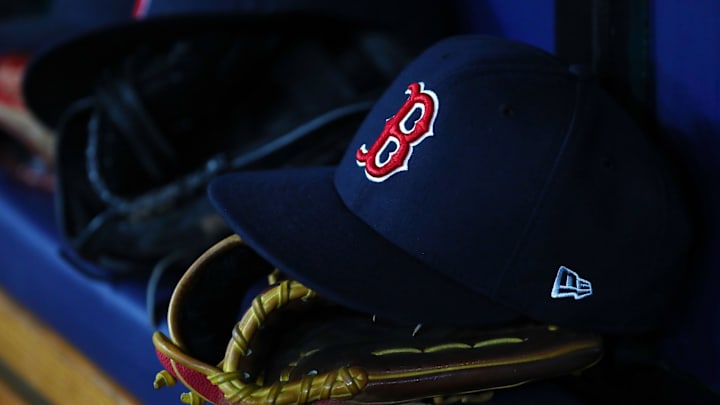 Jul 22, 2019; St. Petersburg, FL, USA; A detail view of Boston Red Sox hat and glove laying in the dugout at Tropicana Field. Mandatory Credit: Kim Klement-Imagn Images