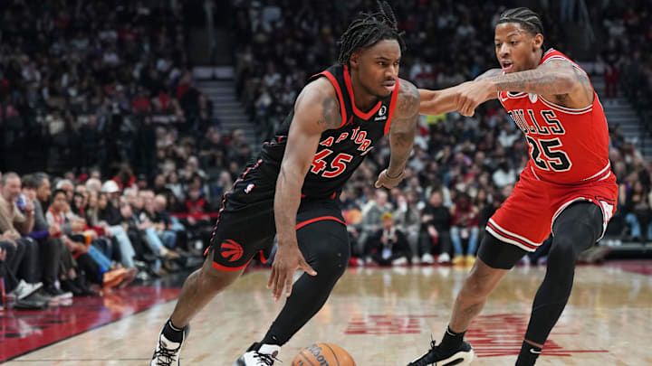 Jan 31, 2025; Toronto, Ontario, CAN; Toronto Raptors guard Davion Mitchell (45) controls the ball as Chicago Bulls forward Dalen Terry (25) tries to defend during the second quarter at Scotiabank Arena. Mandatory Credit: Nick Turchiaro-Imagn Images