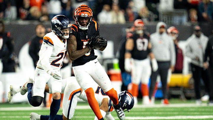 Denver Broncos safety Delarrin Turner-Yell (32) tackles Cincinnati Bengals wide receiver Tee Higgins (5) in overtime of the NFL game at Paycor Stadium in Cincinnati on Saturday, Dec. 28, 2024. Denver Broncos safety Delarrin Turner-Yell (32) tackles Cincinnati Bengals wide receiver Tee Higgins (5) in overtime of the NFL game at Paycor Stadium in Cincinnati on Saturday, Dec. 28, 2024.