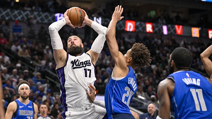 Feb 10, 2025; Dallas, Texas, USA; Sacramento Kings center Jonas Valanciunas (17) shoots over Dallas Mavericks forward Kessler Edwards (20) during the second half at the American Airlines Center. Mandatory Credit: Jerome Miron-Imagn Images