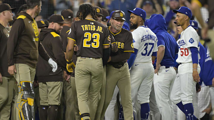 Jun 19, 2025; Los Angeles, California, USA;   San Diego Padres manager Mike Shildt (8) and third base coach Tim Leiper (33) with San Diego Padres right fielder Fernando Tatis Jr. (23) as Los Angeles Dodgers right fielder Teoscar Hernandez (37) and shortstop Mookie Betts (50) look on after benches cleared in the eighth inning at Dodger Stadium. Mandatory Credit: Jayne Kamin-Oncea-Imagn Images