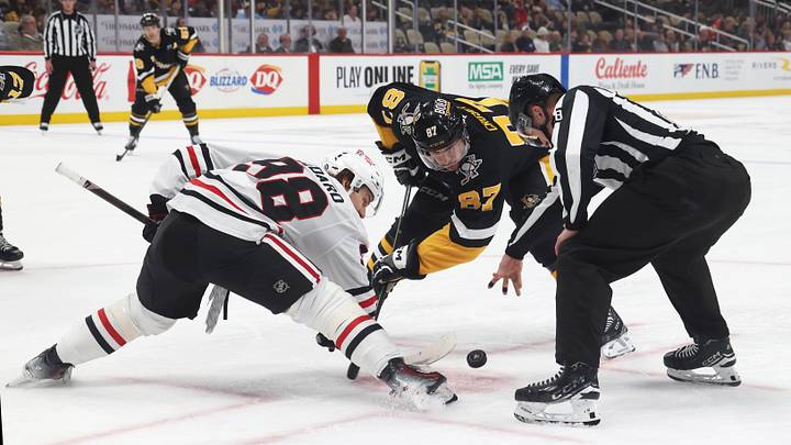 Apr 8, 2025; Pittsburgh, Pennsylvania, USA;  Chicago Blackhawks center Connor Bedard (98) and Pittsburgh Penguins center Sidney Crosby (87) take a third period face-off at PPG Paints Arena. Mandatory Credit: Charles LeClaire-Imagn Images