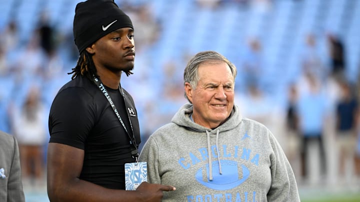 Sep 1, 2025; Chapel Hill, North Carolina, USA;  North Carolina Tar Heels head coach Bill Belichick with a recruit before the game at Kenan Stadium. Mandatory Credit: Bob Donnan-Imagn Images