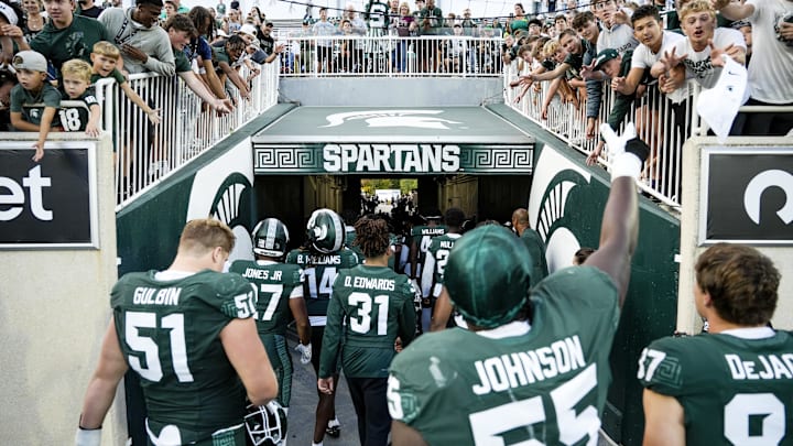 Sep 13, 2025; East Lansing, Michigan, USA; Michigan State offensive lineman Rakeem Johnson (55) throws a towel to fans after a victory over Youngstown State at Spartan Stadium. Mandatory Credit: Brendan Mullin-Imagn Images Sep 13, 2025; East Lansing, Michigan, USA; Michigan State offensive lineman Rakeem Johnson (55) throws a towel to fans after a victory over Youngstown State at Spartan Stadium. Mandatory Credit: Brendan Mullin-Imagn Images