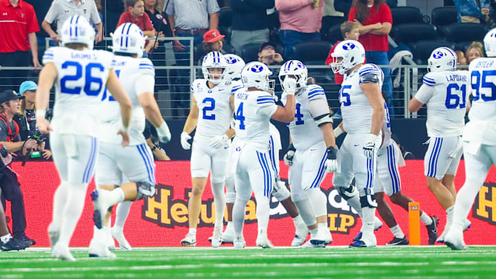 Dec 6, 2025; Arlington, TX, USA;  BYU Cougars running back LJ Martin (4) celebrates with teammates after scoring a touchdown during the first half against the Texas Tech Red Raiders at AT&T Stadium. Mandatory Credit: Kevin Jairaj-Imagn Images