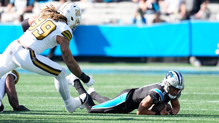Nov 9, 2025; Charlotte, North Carolina, USA;  Carolina Panthers quarterback Bryce Young (9) is sacked as New Orleans Saints defensive end Chase Young (99) defends during the second quarter at Bank of America Stadium. Mandatory Credit: Jim Dedmon-Imagn Images