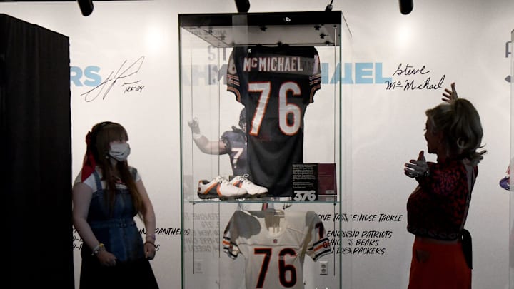 Steve McMichael's jersey was put on display at the Halas Hall lobby after his enshrinement in the Pro Football Hall of Fame, as daughter Macy (left) and wife Misty look on.