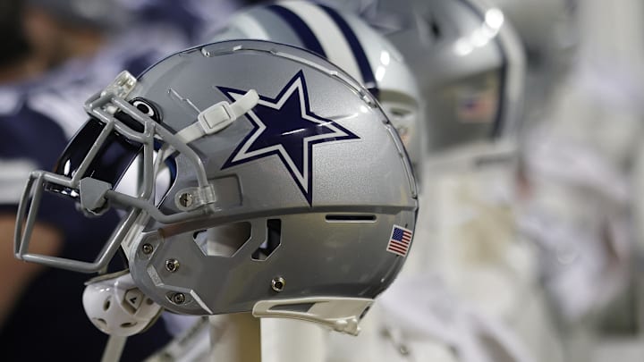 Dallas Cowboys players' helmets rest on the bench against the Washington Commanders at FedExField.