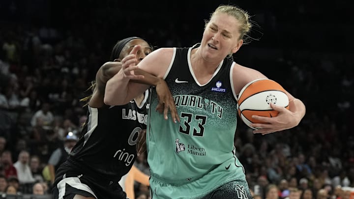 Aug 13, 2025; Las Vegas, Nevada, USA; New York Liberty center Emma Meesseman (33) is fouled by Las Vegas Aces guard Jackie Young (0) during the fourth quarter of their game at Michelob Ultra Arena. Mandatory Credit: Candice Ward-Imagn Images