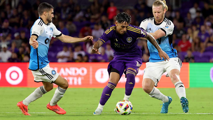 Oct 27, 2024; Orlando, Florida, USA; Orlando City midfielder Facundo Torres (10) dribbles against Charlotte FC midfielder Jamie Paterson (7) and defender Tim Ream (3) during the first half in a 2024 MLS Cup Playoffs Round One match at Inter&Co Stadium. Mandatory Credit: Kim Klement Neitzel-Imagn Images
