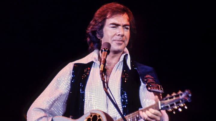 Neil Diamond playing guitar live