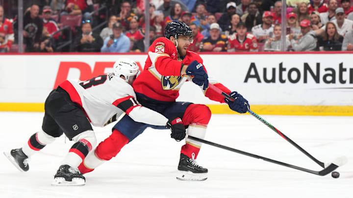 Mar 31, 2026; Sunrise, Florida, USA;  Florida Panthers left wing A.J. Greer (10) takes a short-handed shot on goal as Ottawa Senators center Tim Stutzle (18) defends during the second period at Amerant Bank Arena. Mandatory Credit: Jim Rassol-Imagn Images