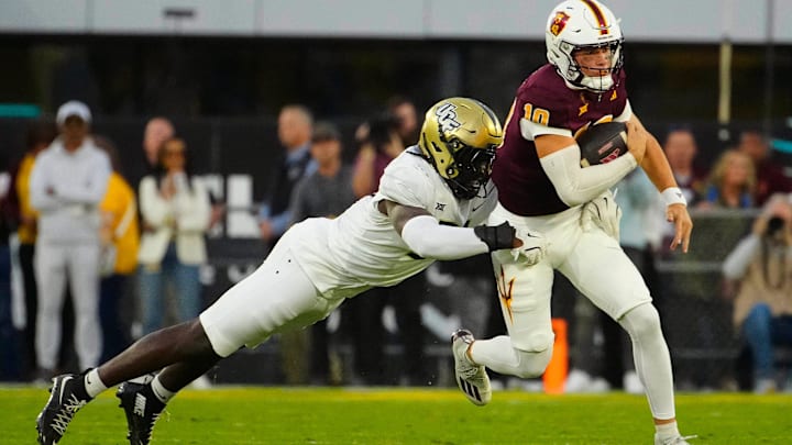 UCF defensive end Malachi Lawrence (51) tackles ASU quarterback Sam Leavitt (10) as he scrambles during a game at Mountain America Stadium in Tempe on Nov. 9, 2024.