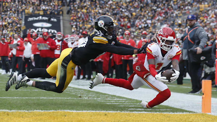 Dec 25, 2024; Pittsburgh, Pennsylvania, USA;  Kansas City Chiefs wide receiver Xavier Worthy (1) dives past Pittsburgh Steelers safety Minkah Fitzpatrick (39) into the end-zone for a touchdown during the first quarter at Acrisure Stadium. Mandatory Credit: Charles LeClaire-Imagn Images