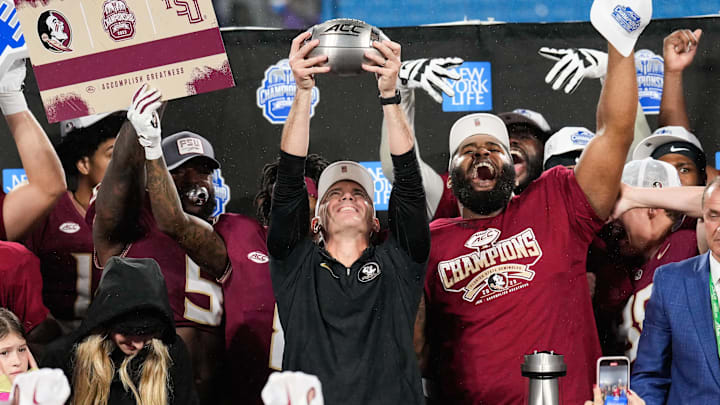 Dec 2, 2023; Charlotte, NC, USA; Florida State Seminoles head coach Mike Norvell raises the ACC