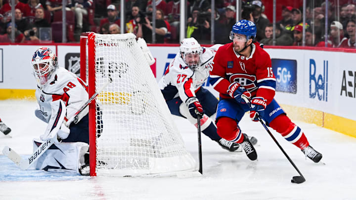 Apr 27, 2025; Montreal, Quebec, CAN; Montreal Canadiens center Alex Newhook (15) plays the puck around the net against Washington Capitals defenseman Alex Alexeyev (27) during the third period in game four of the first round of the 2025 Stanley Cup Playoffs at Bell Centre. Mandatory Credit: David Kirouac-Imagn Images
