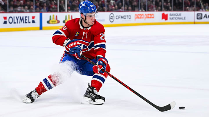 Feb 26, 2026; Montreal, Quebec, CAN; Montreal Canadiens left wing Juraj Slafkovsky (20) plays the puck against the New York Islanders during overtime at Bell Centre. Mandatory Credit: David Kirouac-Imagn Images