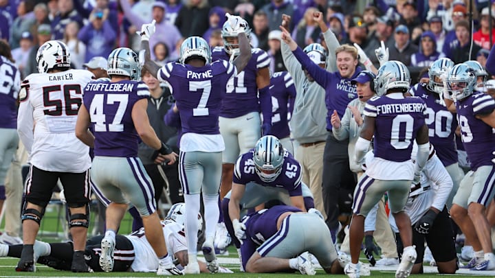 Nov 1, 2025; Manhattan, Kansas, USA; Kansas State Wildcats safety VJ Payne (7) celebrate a fumble recovery with his teammates in the fourth quarter against the Texas Tech Red Raiders at Bill Snyder Family Football Stadium. 