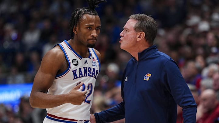 Jan 13, 2026; Lawrence, Kansas, USA; Kansas Jayhawks guard Darryn Peterson (22) talks to head coach Bill Self during the first half against the Iowa State Cyclones at Allen Fieldhouse. Mandatory Credit: Jay Biggerstaff-Imagn Images