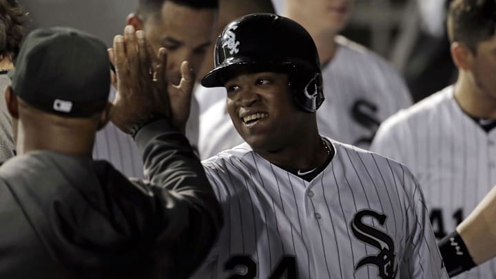 Aug 1, 2014; Chicago, IL, USA; Chicago White Sox right fielder Dayan Viciedo (24) is congratulated by teammates after scoring the game winning run on a single RBI by catcher Tyler Flowers (21) against the Minnesota Twins at U.S Cellular Field. The Chicago White Sox won 10-8. Mandatory Credit: Jon Durr-Imagn Images