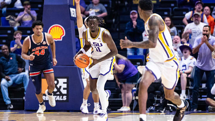 Jan 29, 2025; Baton Rouge, Louisiana, USA;  LSU Tigers forward Corey Chest (11) passes the ball to guard Cam Carter (5) against Auburn Tigers center Dylan Cardwell (44) during the first half at Pete Maravich Assembly Center. Mandatory Credit: Stephen Lew-Imagn Images
