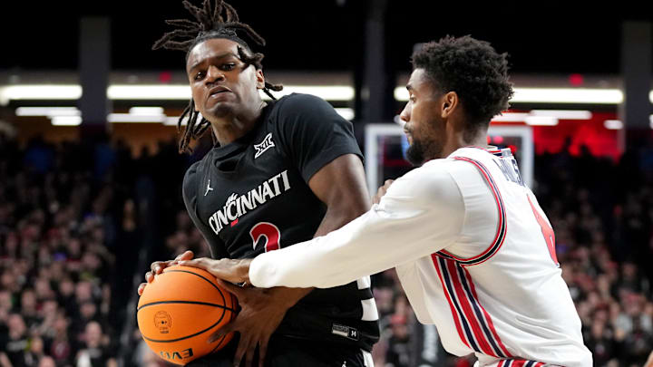 Cincinnati Bearcats guard Jizzle James (2) drives to the basket as Houston Cougars guard Mylik Wilson (8) defends in the first half of an NCAA college basketball game between the Houston Cougars and the Cincinnati Bearcats, Saturday, Feb. 10, 2024, at Fifth Third Arena in Cincinnati. Cincinnati Bearcats guard Jizzle James (2) drives to the basket as Houston Cougars guard Mylik Wilson (8) defends in the first half of an NCAA college basketball game between the Houston Cougars and the Cincinnati Bearcats, Saturday, Feb. 10, 2024, at Fifth Third Arena in Cincinnati.