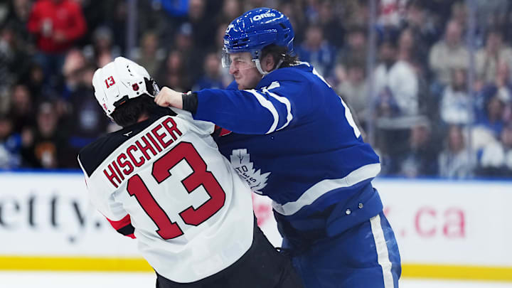 Toronto Maple Leafs left wing Matthew Knies (23) fights with New Jersey Devils center Nico Hischier (13): Nick Turchiaro-Imagn Images