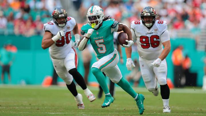 Miami Dolphins running back Jaylen Wright (5) runs for a gain past Tampa Bay Buccaneers defensive end Logan Hall (90) and defensive tackle Greg Gaines (96) during the first quarter at Hard Rock Stadium in the 2025 season. Miami Dolphins running back Jaylen Wright (5) runs for a gain past Tampa Bay Buccaneers defensive end Logan Hall (90) and defensive tackle Greg Gaines (96) during the first quarter at Hard Rock Stadium in the 2025 season.
