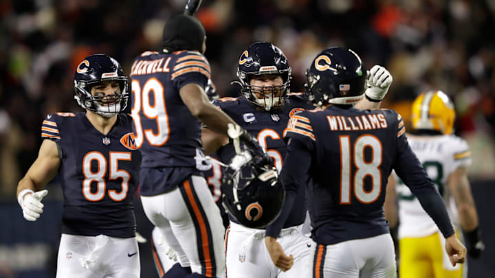 Chicago Bears quarterback Caleb Williams (18) is swarmed by teammates after throwing the game-winning touchdown pass in overtime against the Green Bay Packers during their football game Saturday, December 20, 2025, at Soldier Field in Chicago, Illinois.