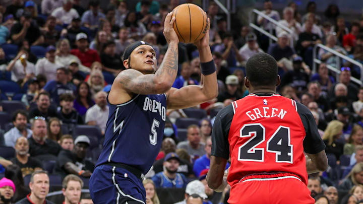 Apr 7, 2024; Orlando, Florida, USA; Orlando Magic forward Paolo Banchero (5) shoots the ball against Chicago Bulls guard Javonte Green (24) during the second quarter at KIA Center. 