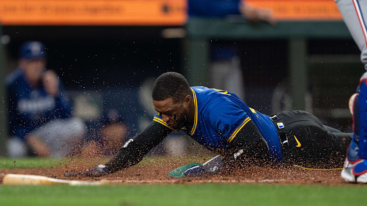 Sep 13, 2024; Seattle, Washington, USA;  Seattle Mariners right fielder Victor Robles (10) slides safely into home plate to score a run during the seventh inning against the Texas Rangers at T-Mobile Park. Mandatory Credit: Stephen Brashear-Imagn Images