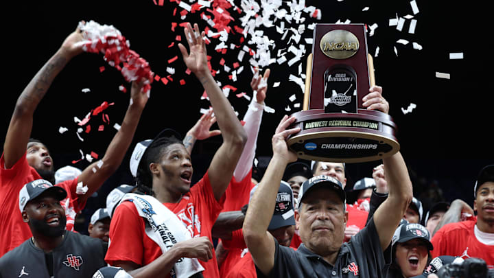 Mar 30, 2025; Indianapolis, IN, USA; Houston Cougars head coach Kelvin Sampson holds the trophy on stage after defeating the Tennessee Volunteers during the Midwest Regional final of the 2025 NCAA tournament at Lucas Oil Stadium. Mandatory Credit: Trevor Ruszkowski-Imagn Images Mar 30, 2025; Indianapolis, IN, USA; Houston Cougars head coach Kelvin Sampson holds the trophy on stage after defeating the Tennessee Volunteers during the Midwest Regional final of the 2025 NCAA tournament at Lucas Oil Stadium. Mandatory Credit: Trevor Ruszkowski-Imagn Images