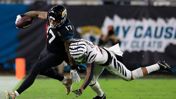 Cincinnati Bengals cornerback DJ Turner II (20) hits Jacksonville Jaguars tight end Evan Engram (17)