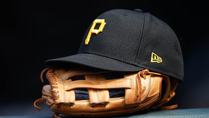 Jun 30, 2021; Denver, Colorado, USA; A general view of a Pittsburgh Pirates glove and hat in the eighth inning against the Colorado Rockies at Coors Field. Mandatory Credit: Isaiah J. Downing-Imagn Images